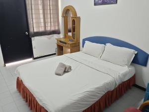 a bedroom with a large bed with a hat on it at VKB Ferringhi Styles Penang formerly Grand Star Hotel in Batu Ferringhi