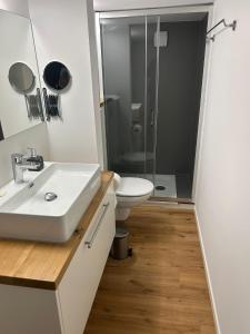 a bathroom with a white sink and a toilet at bei gitta in Olpe