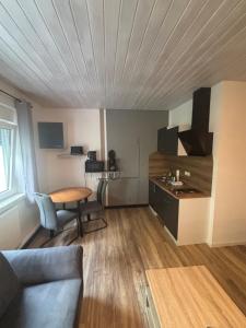 a living room with a couch and a table at Pension Flying Ranch in Dermsdorf +6 photos