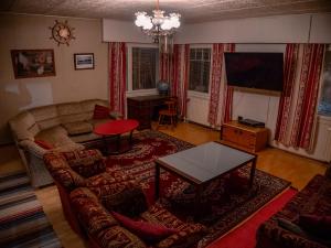 a living room with a couch and a table at Kiinteistö Hetekka in Kouvola