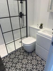 a bathroom with a shower and a toilet and a sink at 1 bedroom flat in Saint Helier Jersey