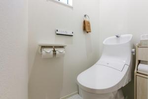 a bathroom with a white toilet in a room at Asobi Stay大日 山吹 in Nagoya +12 photos