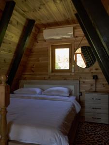 a bedroom with a bed in a wooden cabin at Veis House in Vrba