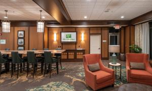 a conference room with a table and chairs at Holiday Inn Stevens Point - Convention Center by IHG in Stevens Point +95 photos