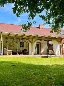 a house with a pavilion with a green lawn at Gajówka in Węgorzewo