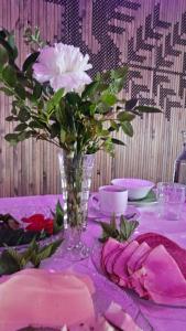 a table with a vase of flowers on a table at Boutique Hotelli Kivennapa in Pieksä