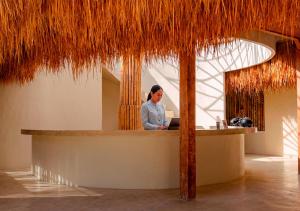 a woman sitting at a counter in a restaurant at Lombok Souls in Senggigi +56 photos