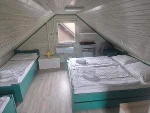 a small bedroom with two beds in a attic at Jack House in Mostec +17 photos