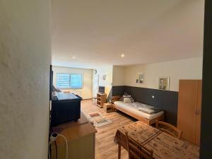 a living room with a couch and a bed at Ferienwohnungen am Main in Erlabrunn +11 photos