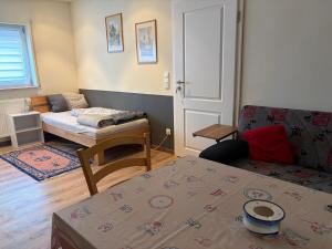 a small room with a bed and a couch at Ferienwohnungen am Main in Erlabrunn