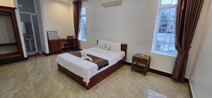 a bedroom with a bed and a table in it at Khmer House Kampot Boutique in Kampot +25 photos