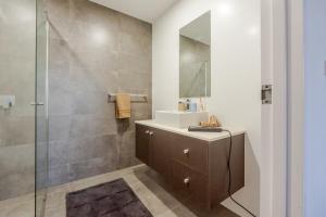 a bathroom with a sink and a shower at On Flinders Wollongong in Wollongong +125 photos