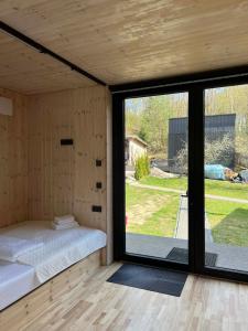 a room with a bed and a large window at Premium homes in VNO