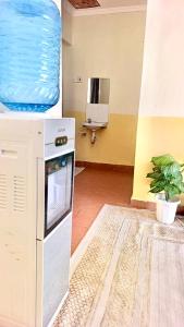 a room with a kitchen with a water tank at Tranquil stays in Bungoma