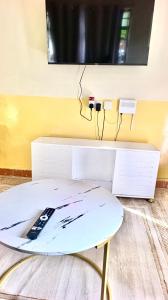 a table with a remote control sitting on top of it at Tranquil stays in Bungoma