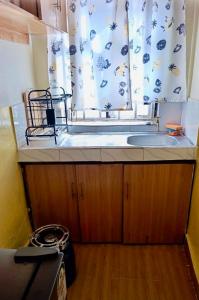 a kitchen with a sink and a window at Tranquil stays in Bungoma