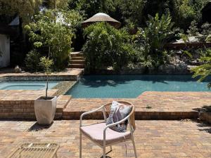 a chair sitting in front of a swimming pool at Tranquility in Cape Town