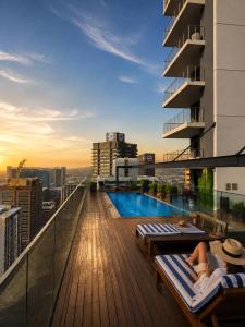 a balcony with a pool on top of a building at Urban Elephant 16 On Bree in Cape Town