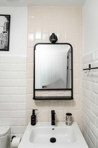a bathroom with a white sink and a mirror at Piso en Casa de Correos in Molina de Aragón +13 photos