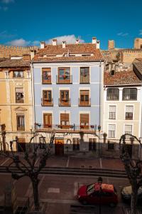 a red car parked in front of a white building at Piso en Casa de Correos in Molina de Aragón