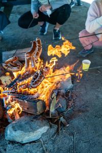 a group of people cooking food over a campfire at Kopuła in Gdynia