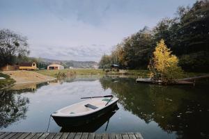 a boat sitting on the water next to a dock at Kopuła in Gdynia