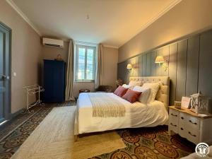 a bedroom with a large bed and a blue cabinet at Un brin lavande in Saint-Couat-dʼAude