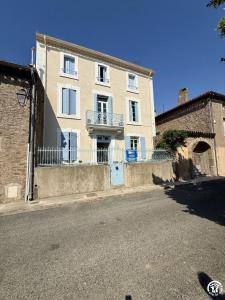 a large brick building on the side of a street at Un brin lavande in Saint-Couat-dʼAude