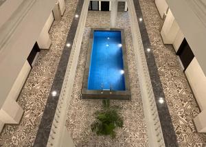 an overhead view of a swimming pool in a building at Front One Hotel Mesir Surabaya in Surabaya