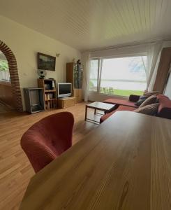 a living room with a couch and a table at Sommerhaus Seeblick in Klausdorf Brandenburg