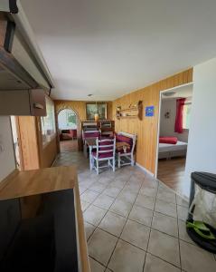 a kitchen and living room with a table and chairs at Sommerhaus Seeblick in Klausdorf Brandenburg