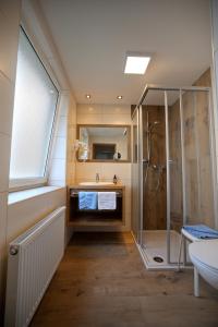 a bathroom with a shower and a sink at Pension Gstrein in Bad Hofgastein +62 photos