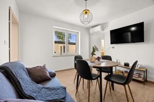 a living room with a couch and a table at Danijela Holiday Home in Labin