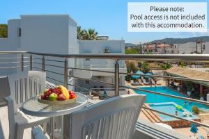 a bowl of fruit on a table on a balcony at Economisa Apartments in Ialysos
