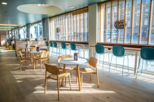 a waiting room with tables and chairs and windows at Edinburgh Central Accommodation in Edinburgh +31 photos