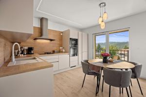 a kitchen and dining room with a table and chairs at Danijela Holiday Home in Labin