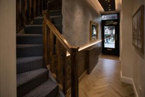 a staircase in a building with a stair case at Paddington Townhouse Hotel by OYO in London