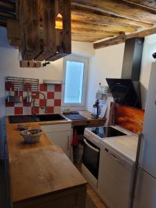 a kitchen with a sink and a stove top oven at The Cozy Collo House in Collobrières