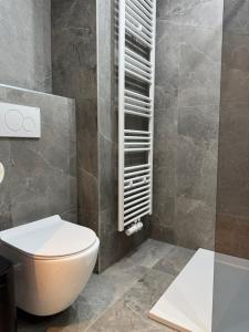 a bathroom with a white toilet and a sink at Arku apartments Brussels Airport in Zaventem +52 photos