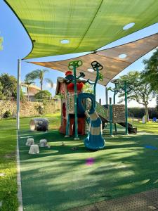 a park with a playground with a slide at ODAR suite in Caesarea