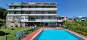 a hotel with a swimming pool in front of a building at Las Islas in Vilaboa