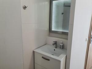 a white bathroom with a sink and a mirror at Zimmer-Vermietung an der Ostsee, neben der Median-Klinik in Wismar +23 photos