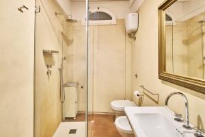 a bathroom with a toilet and a sink and a shower at Casa Becci Central Large & Sunlit Historical Flat in San Gimignano +14 photos