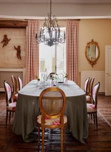 a dining room with a table with chairs and a chandelier at Villa Privée avec Piscine - Lavy in Saint-Pierre-de-Côle