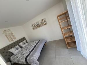 a bedroom with a bed and a book shelf at Lou Cigalou Clim, jardin privé, parking & Wi-Fi 1 à 4 pers in Avignon