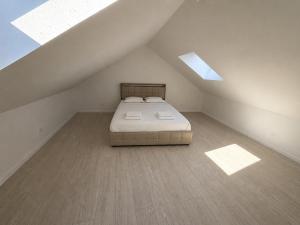 a bedroom with a bed in a attic at T3 proche musées et panorama in Château-Chinon