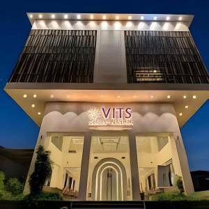 a white building with a vittles sign on it at VITS Select Nashik in Nashik