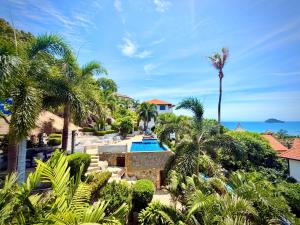 an aerial view of a resort with a swimming pool and palm trees at Viking House Villa Deluxe in Ko Tao