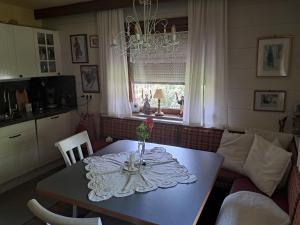a dining room table with a vase of flowers on it at Bergblick in Schwaz +4 photos