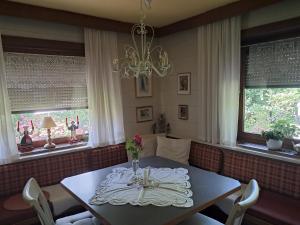 a dining room with a table and two windows at Bergblick in Schwaz